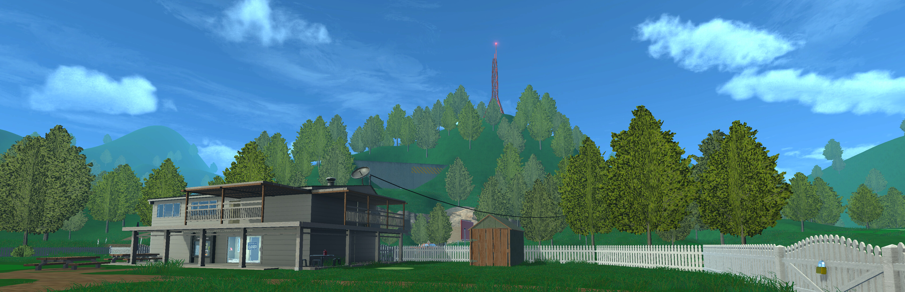 Normal Golf Game course view: the clubhouse beside a white picket fence with a wooded hill and radio tower behind it